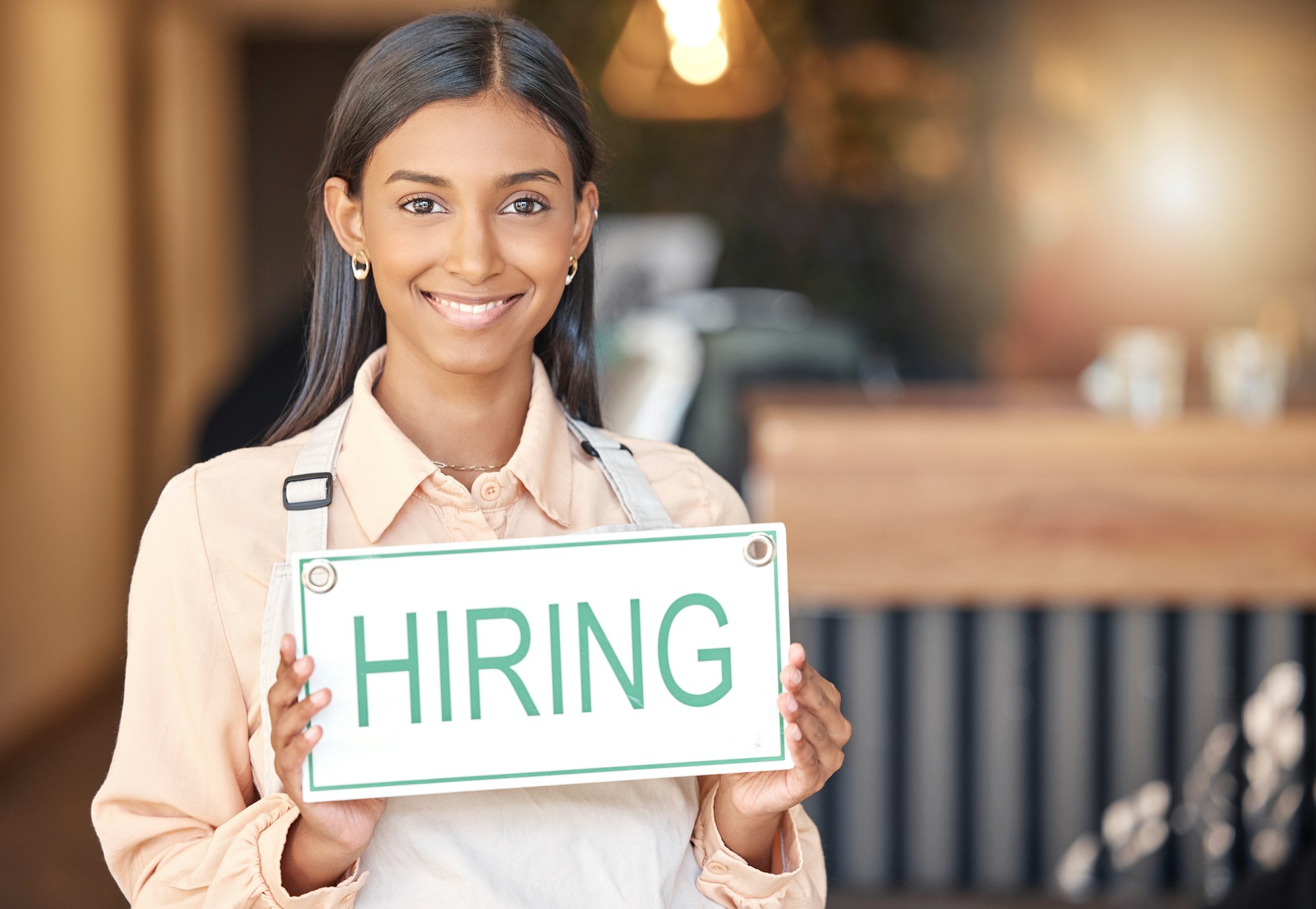 Woman, hiring sign and portrait smile in small business for recruitment, hire or job opportunity at
